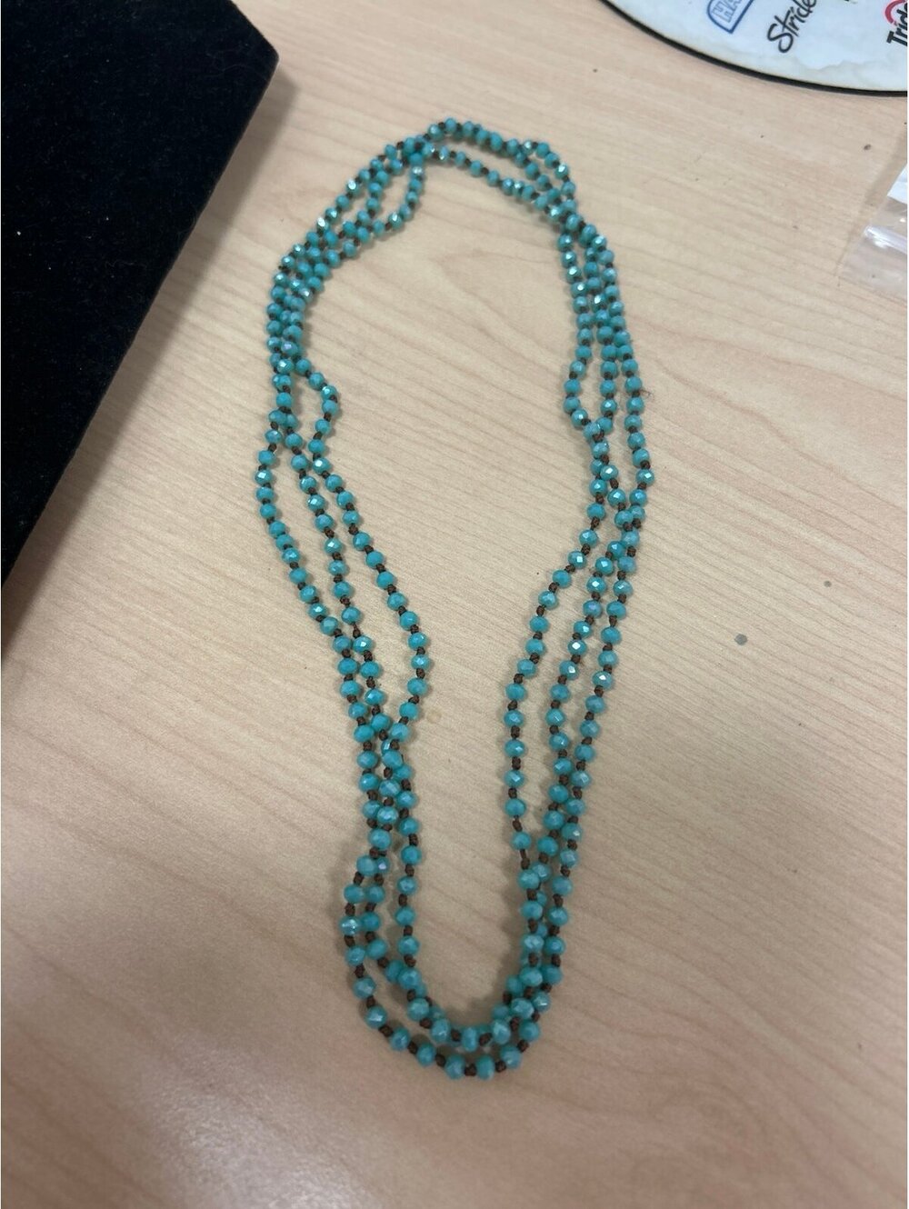 long, multi-strand turquoise-colored faceted crystal bead necklace